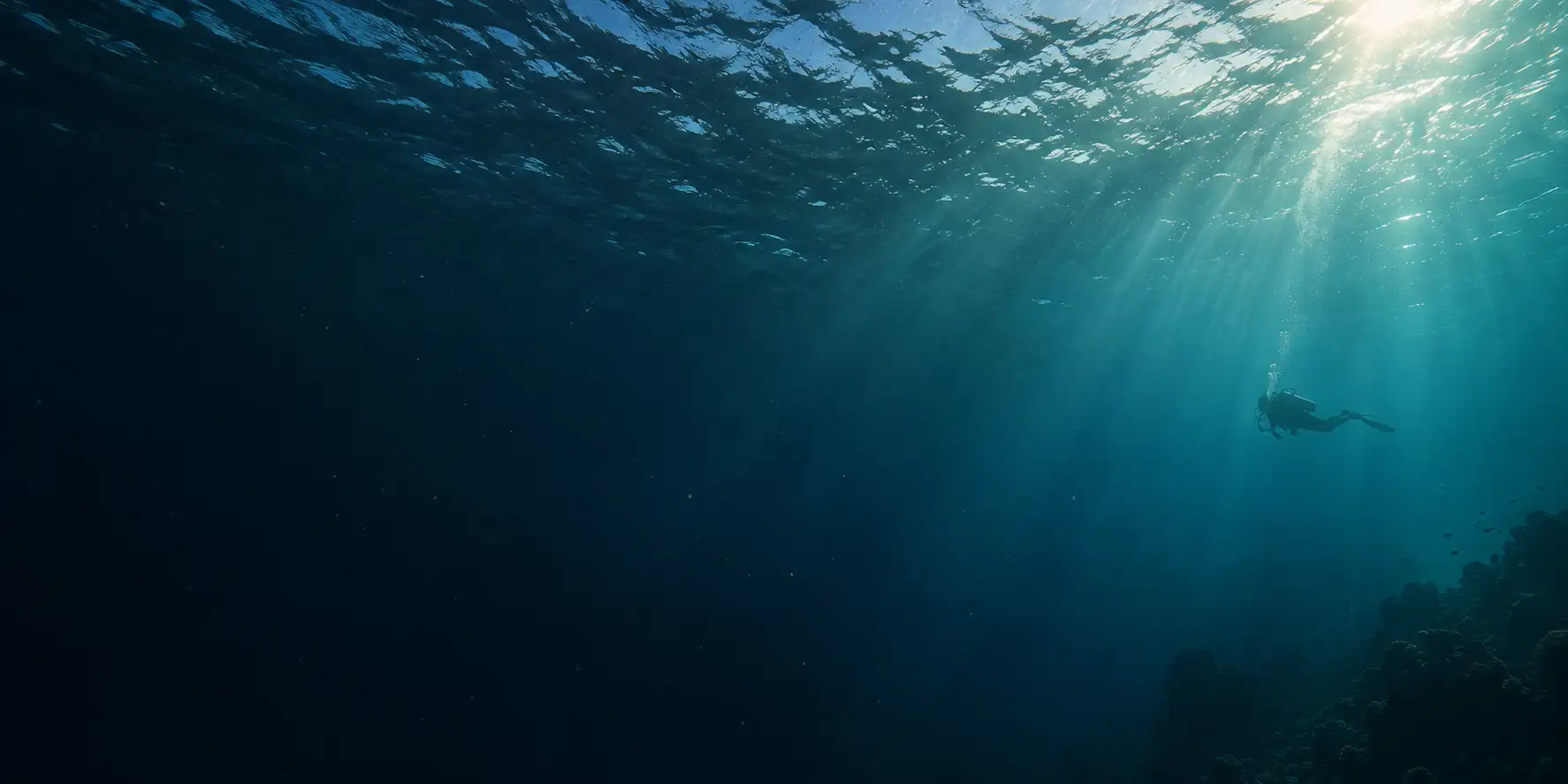 Underwater illustration of a distant diver beneath shafts of sunlight and a rippled surface