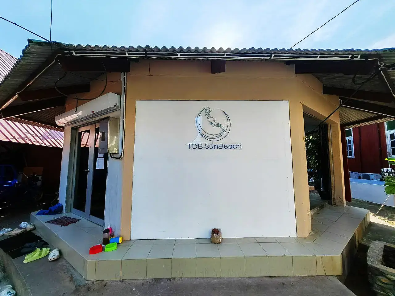 Entrance to the TDB SunBeach building with the centre sign above the doorway.